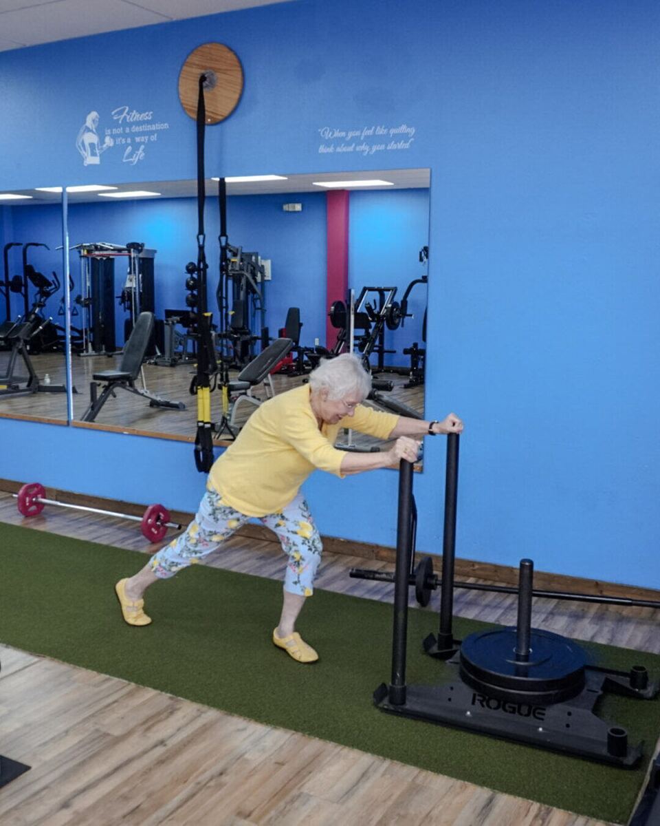 The same member pushing a weighted sled